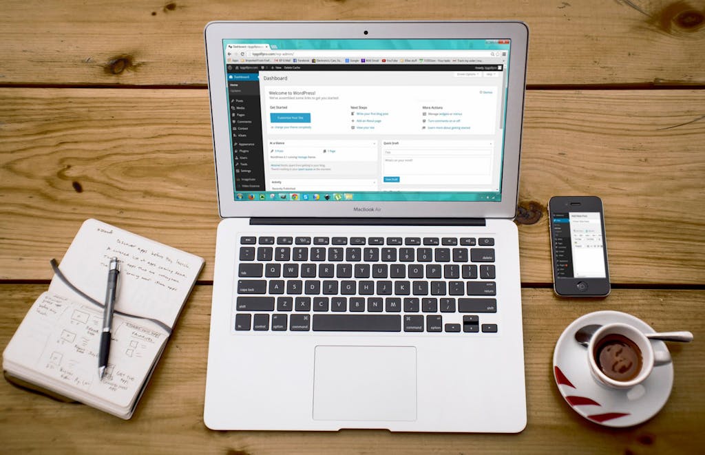 A cozy home office scene with a laptop, notebook, smartphone, and coffee, perfect for productivity in content strategy